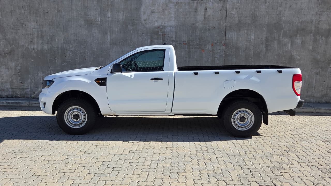 A white 2021 Ford Ranger 2.2 XL single cab with steel wheels parked side-on on paving against a bare concrete wall
