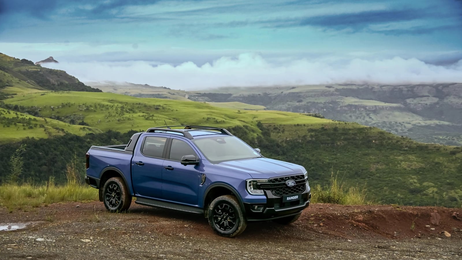 A Ford Ranger double cab parked on a hillside in the Drakensberg foothills