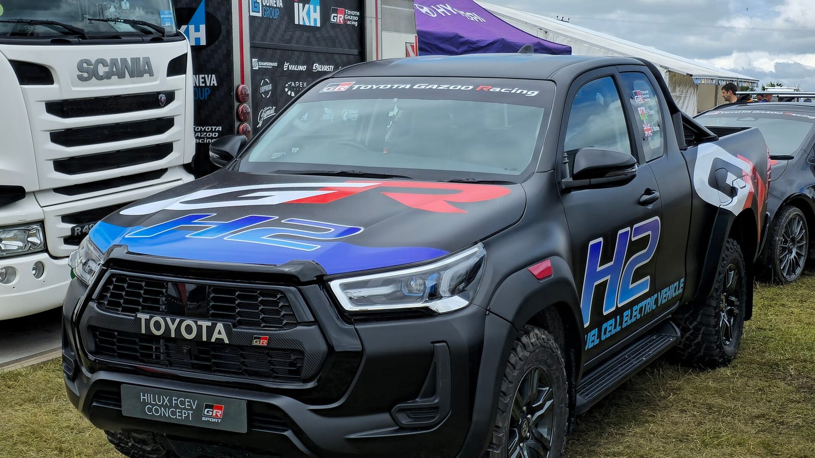 The black Toyota Hilux FCEV Concept in GR Sport dress with H2 fuel cell electric vehicle graphics