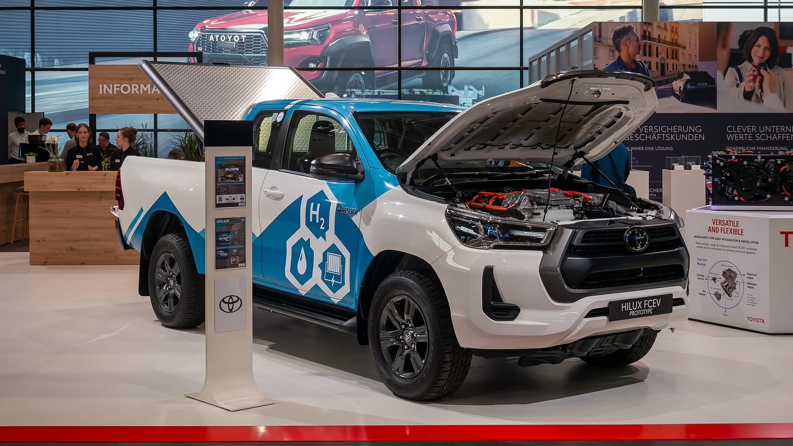 The white and blue Toyota Hilux FCEV prototype on the Toyota stand at IAA Transportation 2024 in Hanover with its bonnet raised