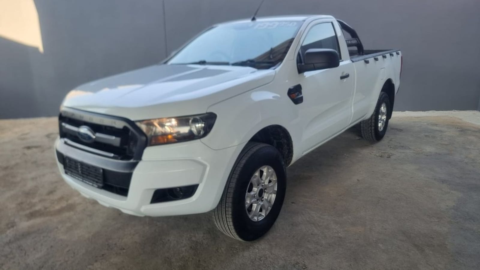 A white 2018 Ford Ranger 2.2 TDCi XL 4x4 single cab with a bare load bin and sports bar, parked on a gravel yard in Rustenburg