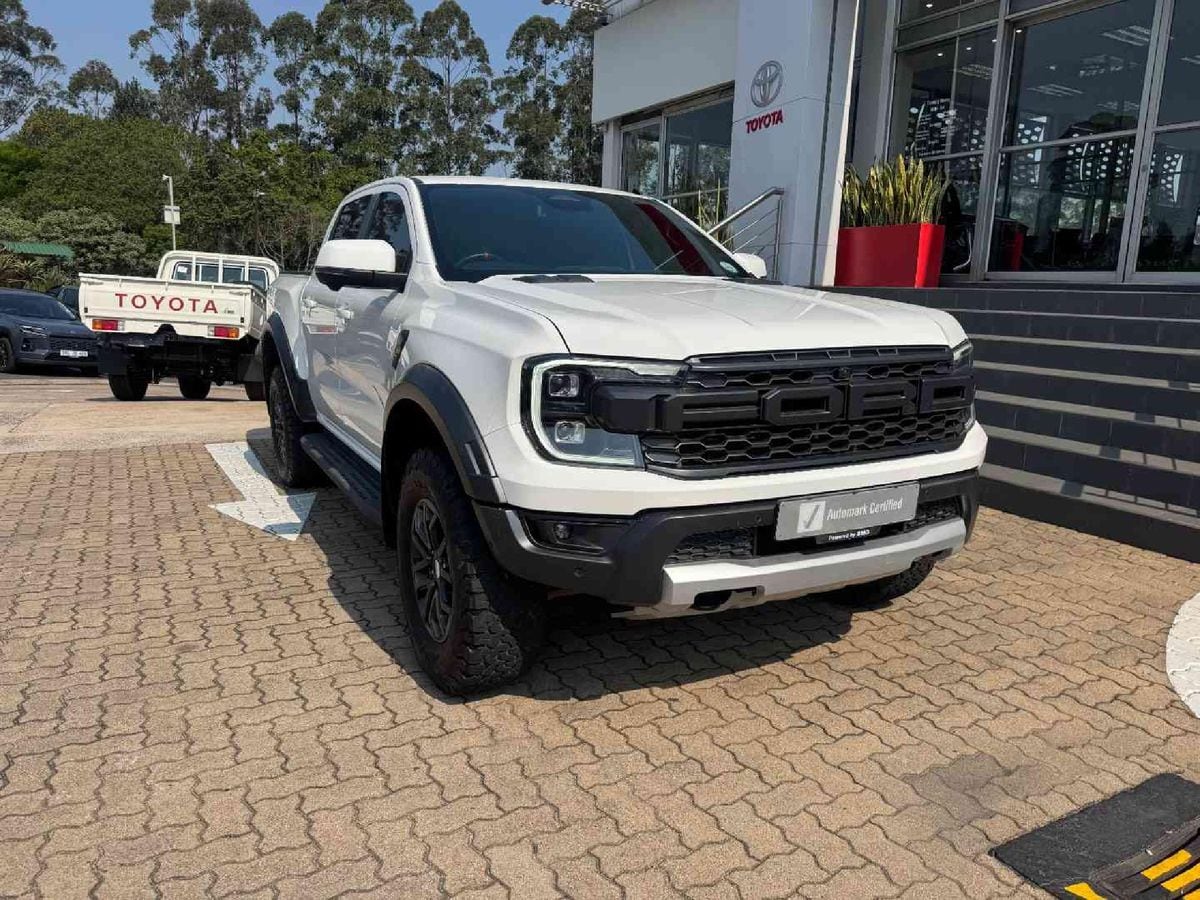 A white 2024 Ford Ranger Raptor 3.0 V6 on the forecourt of a Toyota dealership in Hillcrest, KwaZulu-Natal, with a Land Cruiser 79 parked behind it