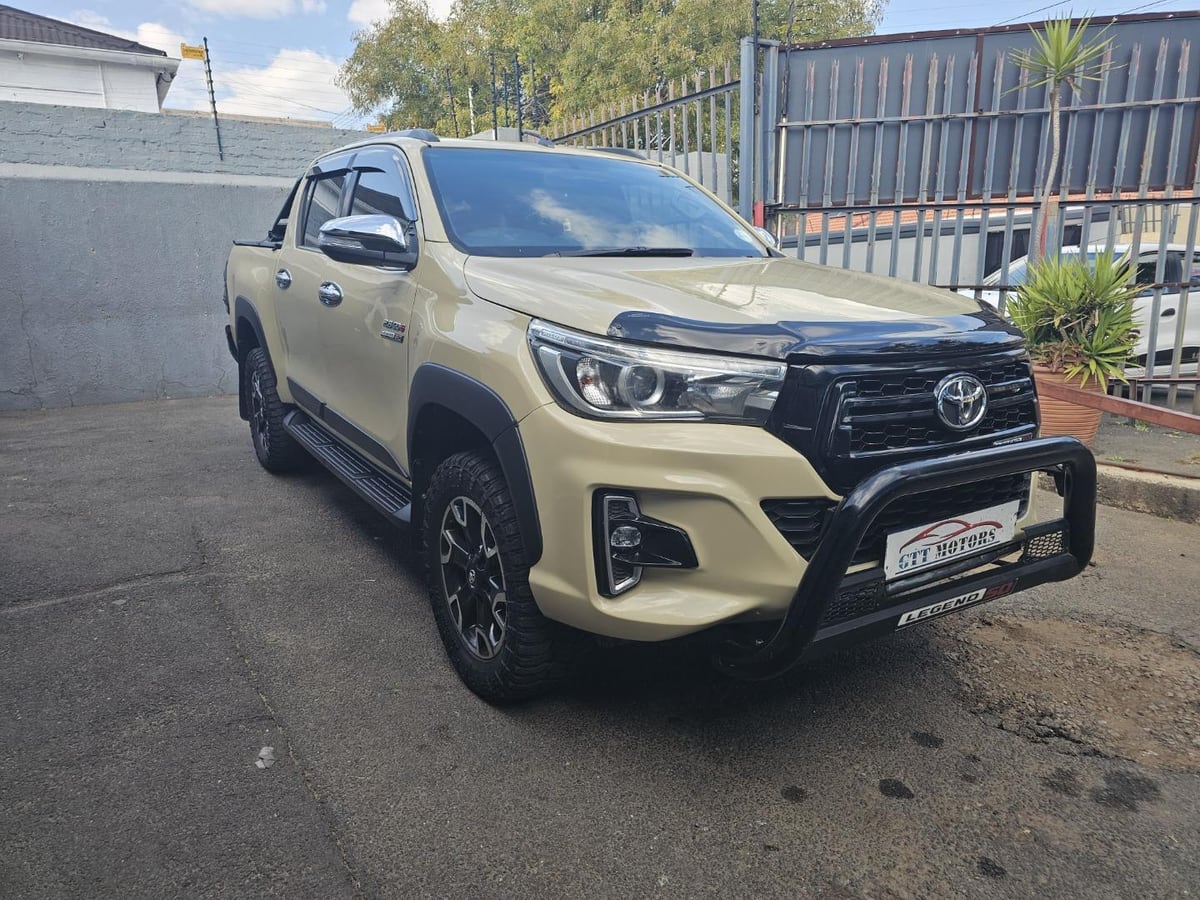 A sand-coloured 2020 Toyota Hilux 2.8 GD-6 Legend 50 4x4 automatic double cab with a black nudge bar, parked in a Johannesburg yard