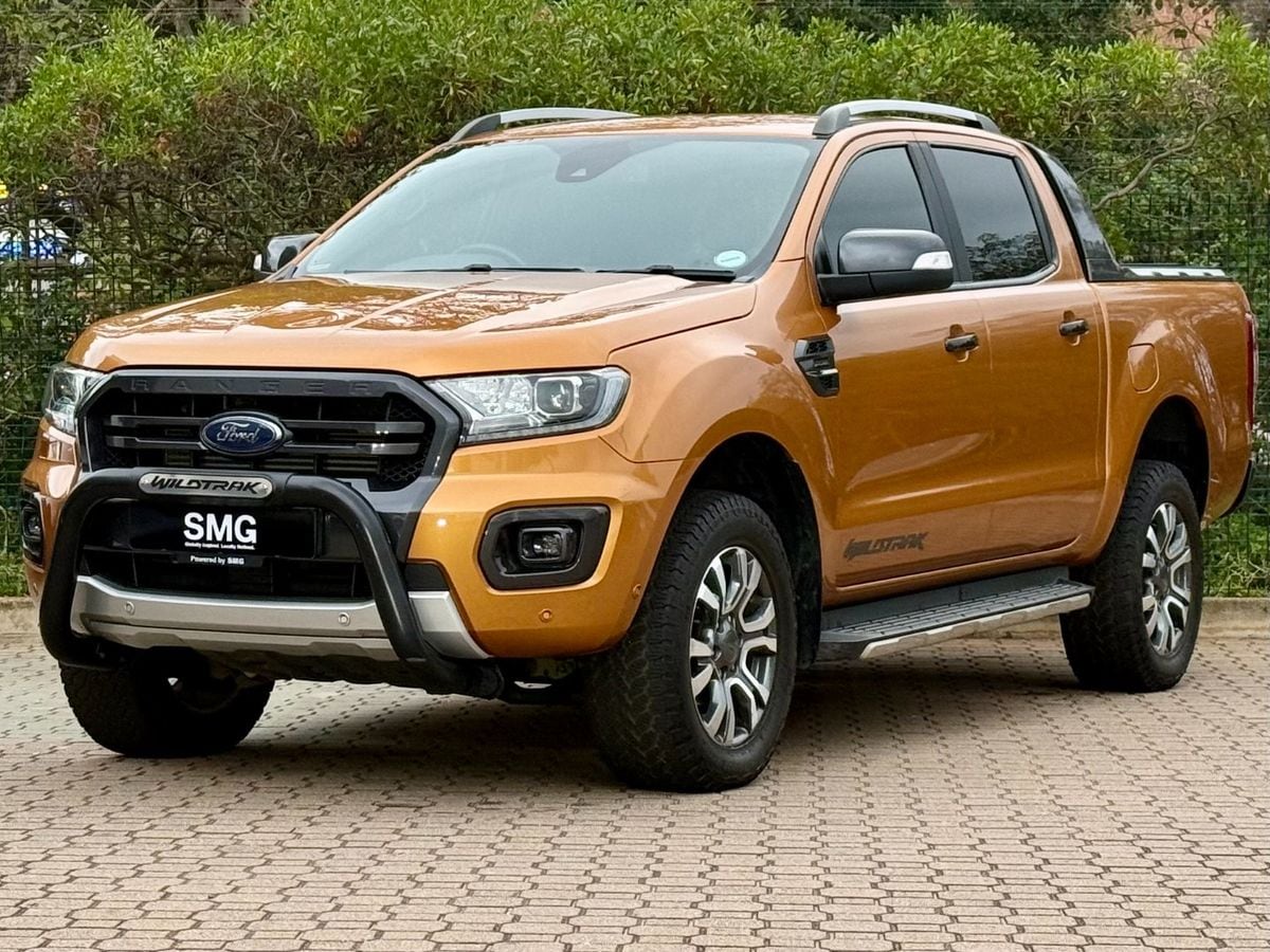 A Saber orange 2021 Ford Ranger 2.0 Bi-Turbo Wildtrak 4x4 automatic double cab parked on paving in front of a hedge in KwaZulu-Natal